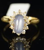 Star sapphire and diamond ring, oval cabochon cut star sapphire, four claw set, with a surround of