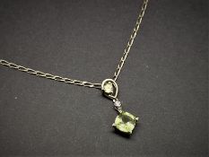 Peridot and diamond necklace, set in yellow metal stamped 9ct, on a yellow metal chain tested as