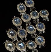 Lot of fourteen paste set clasps, mounted in unmarked white metal, blue and white paste stones,