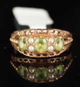 A peridot and pearl carved half hoop ring, three oval cut peridot, each separated by two seed