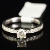 Single stone diamond ring, round brilliant cut diamond with diamond set shoulders, mounted in