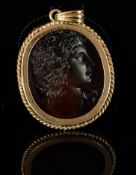 Intaglio cameo pendant, mounted in yellow metal with a partial stamp, rope design border, cameo of a