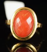 Single stone coral ring, oval chequerboard cut coral, in a yellow gold mount, with Italian marks for