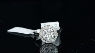 NEW OLD STOCK, UNWORN RETIRED STOCK - A diamond cluster ring, set with round brilliant cut