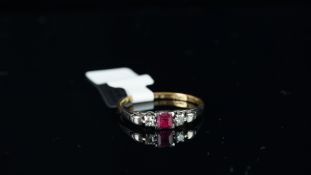 Three stone ruby and diamond ring, mounted in yellow and white metal stamped '18CT PLAT', central