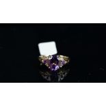 Amethyst and diamond ring, mounted in unmarked yellow metal, central oval amethyst with one round