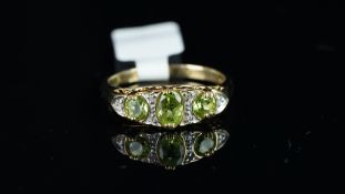 Peridot and diamond ring, mounted in hallmarked 9ct yellow gold, in carved half hoop style, finger