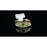 Peridot and diamond ring, mounted in hallmarked 9ct yellow gold, in carved half hoop style, finger