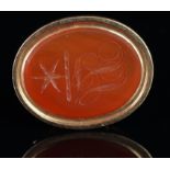 A carnelian seal fob, with an openwork gold handle, tested as 9ct, oval carnelian seal depicting the