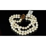 A freshwater pearl, three strand bracelet, 6mm white pearls, with pinkish overtones, on a gilt metal