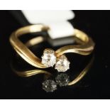 Two stone diamond crossover ring, mounted in yellow metal stamped 18ct, two round old cut diamonds