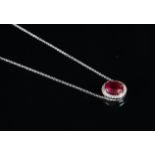 A synthetic ruby and diamond cluster pendant, central oval cut synthetic ruby, surrounded by round