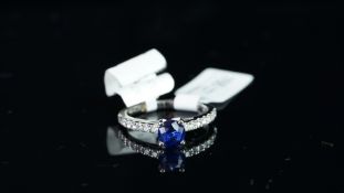 NEW OLD STOCK, UNWORN RETIRED STOCK - A sapphire and diamond ring, central round cut sapphire