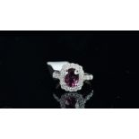 A spinel and diamond cluster ring, central oval cut purple spinel, weighing an estimated 2.03ct,