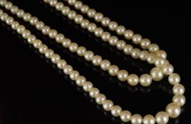 Double row of graduated pearls, strung unknotted on a diamond set flower design clasp, pearls