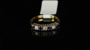 Seven stone sapphire and diamond half eternity ring, mounted in hallmarked 18ct yellow gold with