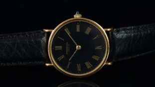 GENTLEMEN'S RAYMOND WEIL WRISTWATCH, circular black dial with gold Roman numerals and hour hands,