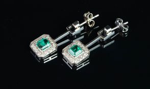 Emerald and diamond cluster earrings, single emerald cut emerald to centre, approximately 5.64 x 5.