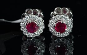 NEW OLD STOCK, UNWORN RETIRED STOCK - A pair of ruby and diamond stud earrings, round cut rubies