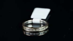 Baguette cut diamond half eternity ring, mounted in unmarked white metal tested as 18ct gold,
