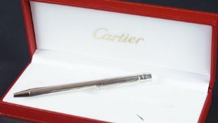 Cartier ballpoint pen in white metal, stamped with serial number 134218, in fitted Cartier red