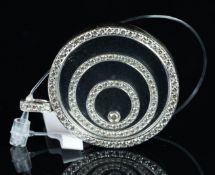 Fancy diamond pendant, diamonds set as concentric circles floating between glass, diamond set border
