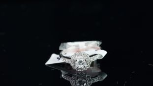 NEW OLD STOCK, UNWORN RETIRED STOCK - A diamond cluster ring, set with a central round brilliant cut