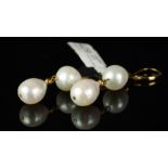 A pair of freshwater pearl earrings, two pearls set from a yellow metal hook, stamped 14k, gross