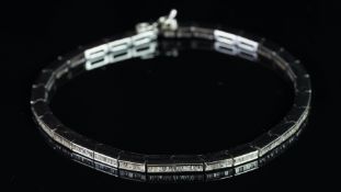 A diamond set line bracelet, comprising of rectangular articulated links, twenty-six links, each set