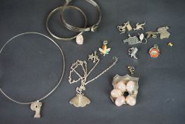 A selection of silver and costume jewellery, including brooches, pendants and charms