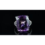 An amethyst and diamond ring, cushion cut amethyst weighing 17.23ct, 'Russian Violet' colour, with