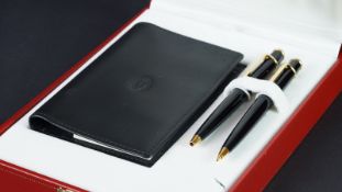 Boxed pen and pencil set by Cartier, including a propelling pencil and a ballpoint pen, with black