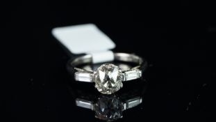 Three stone old cut diamond and baguette cut diamond ring, mounted in white metal stamped '18ct &