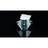 An aquamarine and diamond ring, rectangular mixed cut Brazilian aquamarine, weighing an estimated