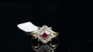 Red stone and diamond cluster ring, mounted in unmarked rose coloured metal, central square shaped