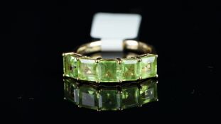 A five stone peridot ring, weighing an estimated total of 3.00ct mounted in 9ct rose gold,