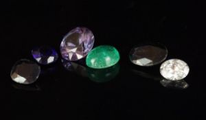 Selection of one natural cabochon emerald, one round zircon and four synthetic sapphires of