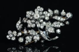 Old cut diamond floral brooch, mounted in unmarked white metal, with a yellow metal pin and tube