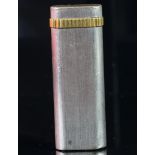 Cartier white and yellow metal lighter, serial number 1 98096, weight approximately 78.9 grams. A/