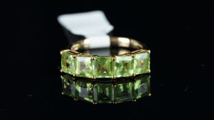 A five stone peridot ring, weighing an estimated total of 3.00ct mounted in 9ct rose gold,