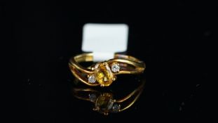 A yellow sapphire and diamond ring, central oval cut yellow sapphire weighing an estimated 0.60ct,