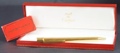 Must de Cartier gold cased ballpoint pen, serial number 142403, with two refills, international