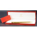 Must de Cartier gold cased ballpoint pen, serial number 142403, with two refills, international