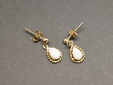 Opal drop earrings, pear cabochon opals, set in 9ct yellow gold.