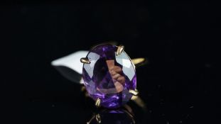 Single stone amethyst ring, mounted in hallmarked 9ct yellow gold, oval mixed cut amethyst, stated