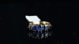 A five stone sapphire ring, five cushion mixed cut sapphires weighing an estimated total of 2.