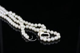 Triple row cultured freshwater pearl necklace, knotted and strung on a 9ct gold pearl set clasp,