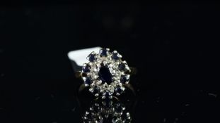 A sapphire and diamond cluster ring, mounted in 9ct yellow gold, hallmarked London 1975, gross