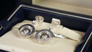 Chopard Happy Spirit earrings, heavy white metal surround with a free floating circular disc and a