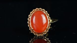 Single stone cornelian ring, mounted in unmarked yellow metal tested as 18ct gold, oval cabochon